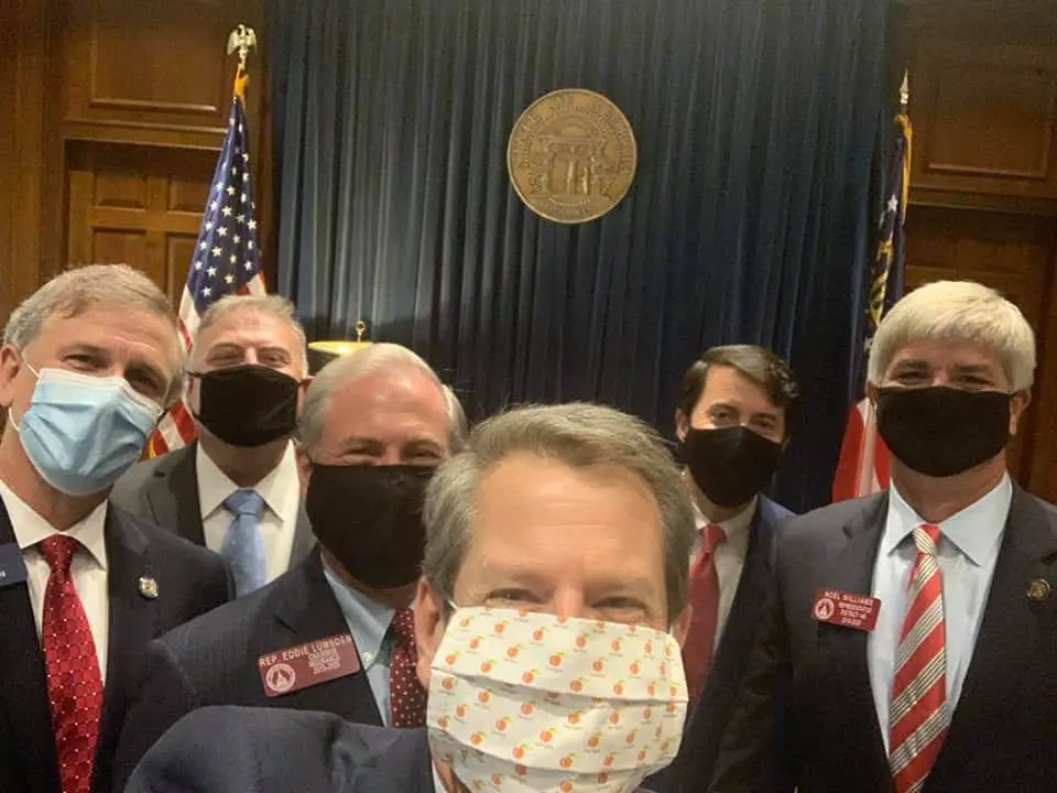 Hundreds of Georgia health care workers are urging Gov. Brian Kemp to require people to wear face masks in public.