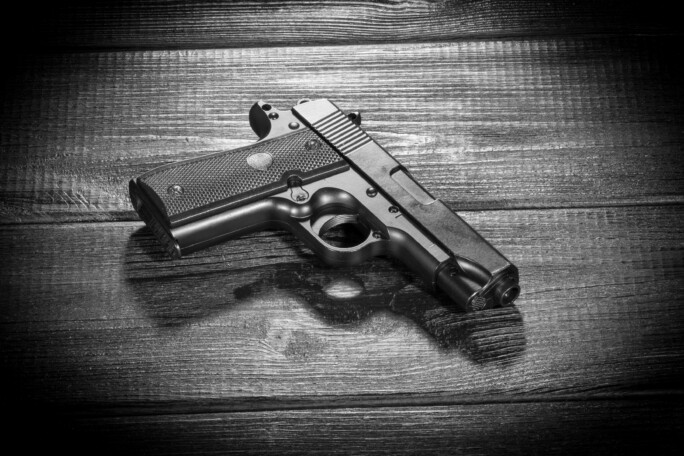 Airsoft gun replica on dark background