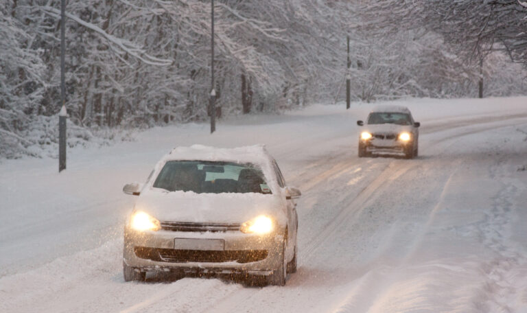 Two Cars Driving in Snow