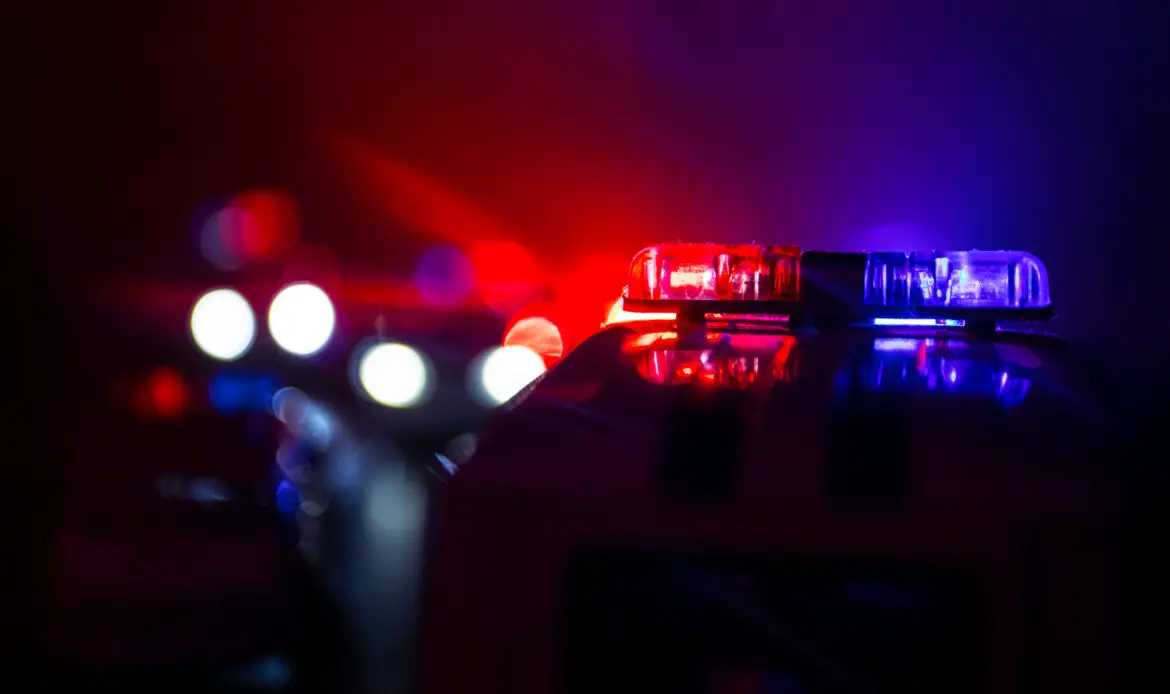 Police cars at night. Police car chasing a car at night with fog background. 911 Emergency response police car speeding to scene of crime. Selective focus