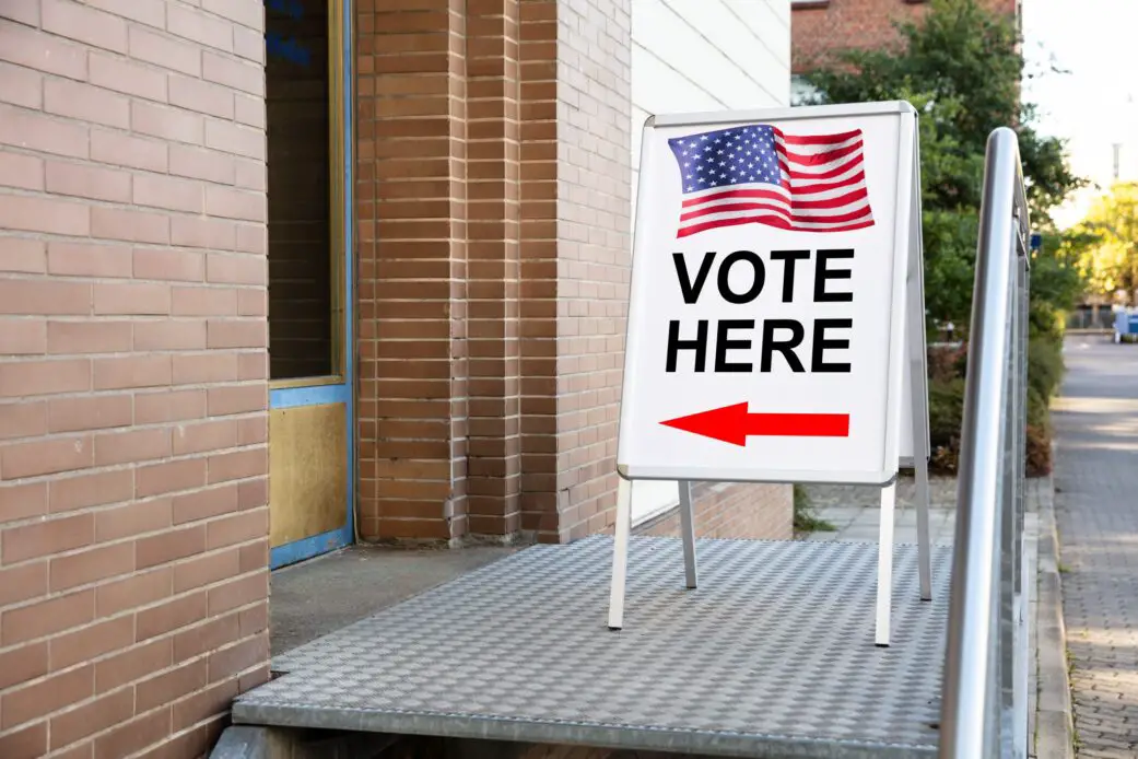 Polling Place Vote Here Sign On White Board Near House