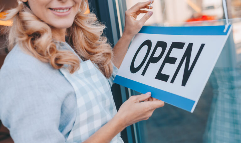 waitress with sign open