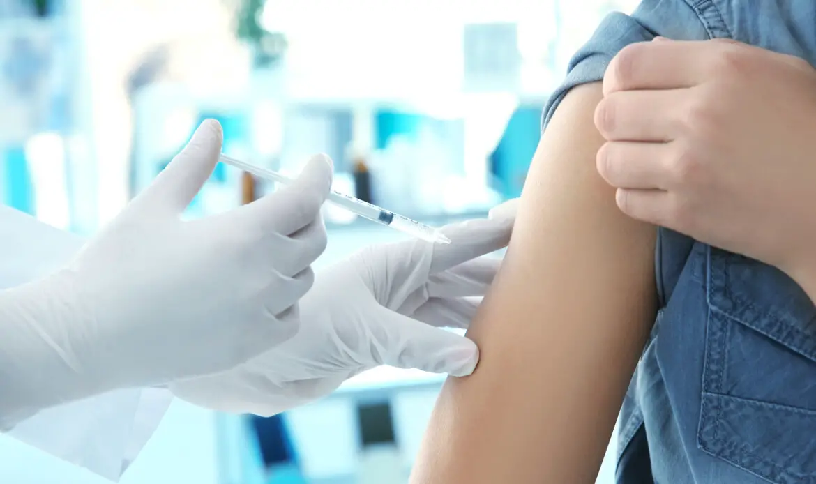 Doctor vaccinating patient in clinic