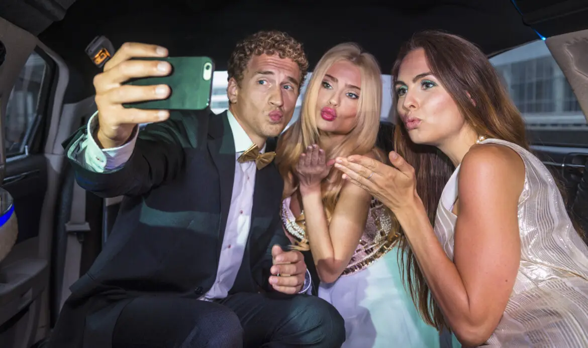 Friends taking a selfie in the back of a limousine