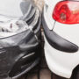 Dense parking on busy city streets - two cars are touching each other by bumpers - contact parking