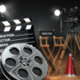 Video, movie, cinema concept. Retro camera, reels, clapperboard