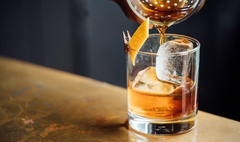 liquor pouring on clear shot glass