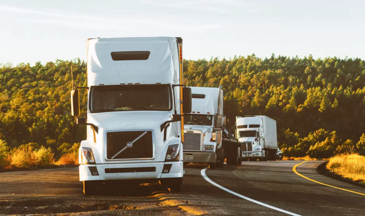 White volvo semi truck on side of road