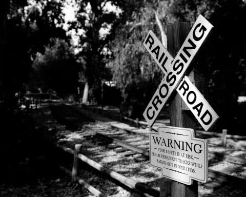 Railroad crossing sign near railway