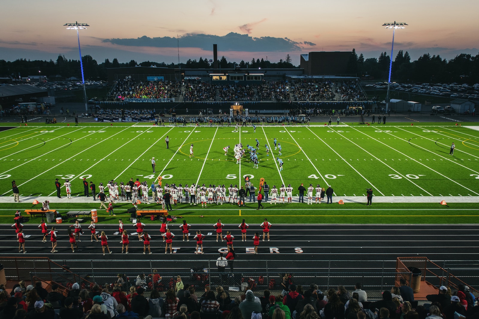 a football field with a crowd watching