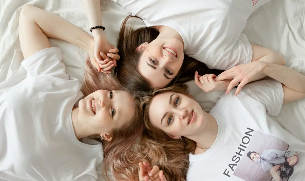 Three Women Lying On Bed