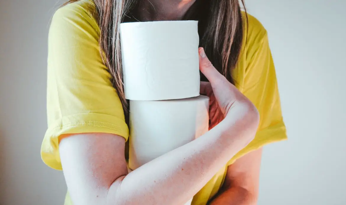 woman in yellow t-shirt holding white tissue paper