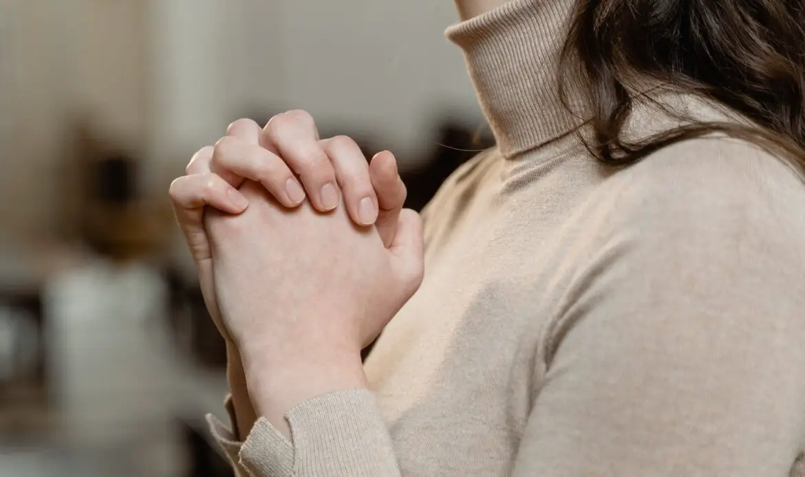 Woman in Brown Turtle Neck Shirt with Hands Clasped