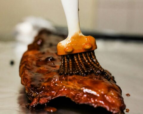 a close up of a brush cleaning a piece of meat