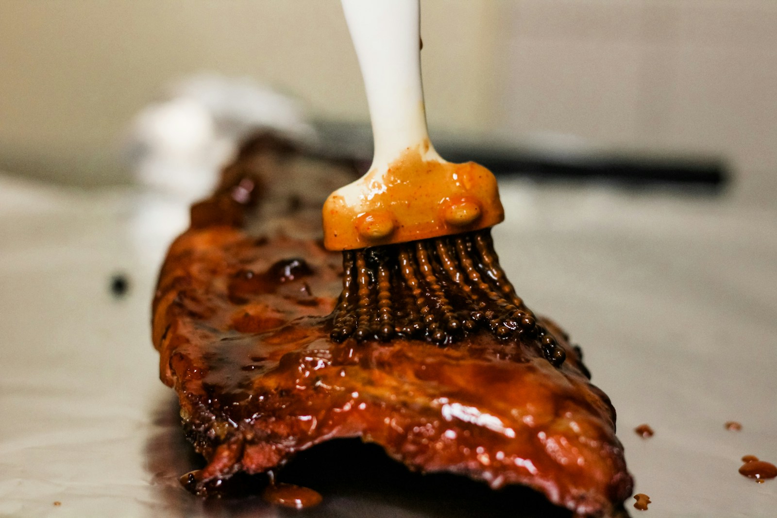 a close up of a brush cleaning a piece of meat