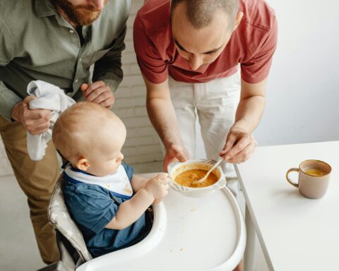 Parents Feeding Baby at Breakfast