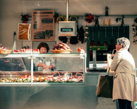 A man standing in front of a counter filled with food