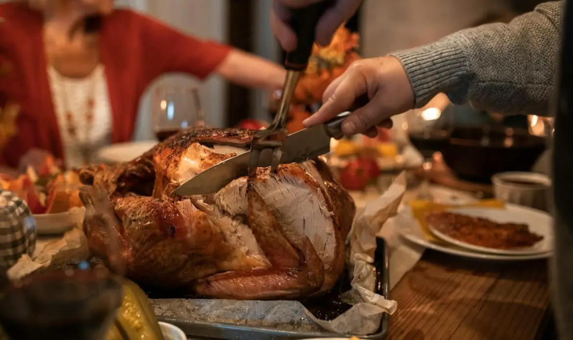 Celebrate Thanksgiving with a roast turkey feast and family around a cozy dinner table indoors.