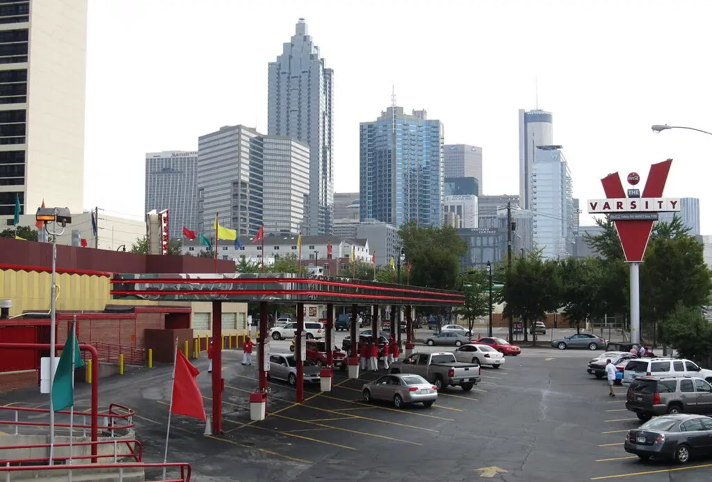 The Varsity, Atlanta's renowned drive-in restaurant, has been serving iconic fast food since 1928. Known for its massive size, unique ordering lingo, and signature Frosted Orange drink, it draws locals and visitors alike. The restaurant maintains its commitment to affordable pricing and has expanded to multiple locations while preserving its historical charm.