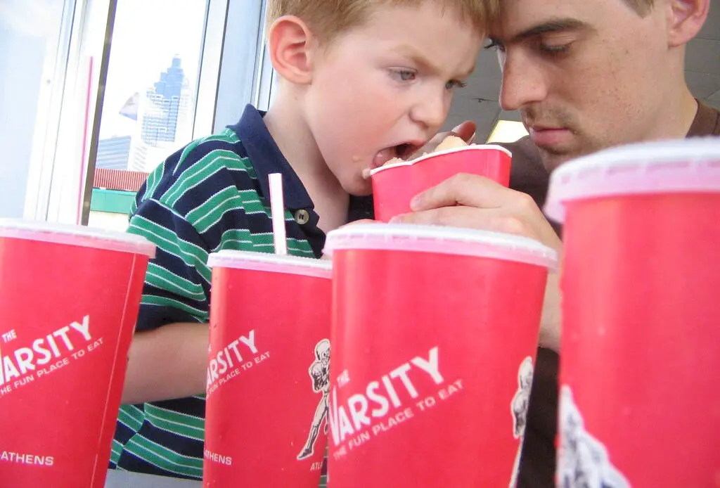 The Varsity, Atlanta's renowned drive-in restaurant, has been serving iconic fast food since 1928. Known for its massive size, unique ordering lingo, and signature Frosted Orange drink, it draws locals and visitors alike. The restaurant maintains its commitment to affordable pricing and has expanded to multiple locations while preserving its historical charm.