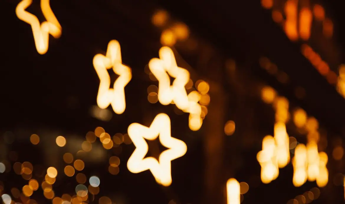 Star-shaped bokeh lights creating a warm and festive nighttime atmosphere.