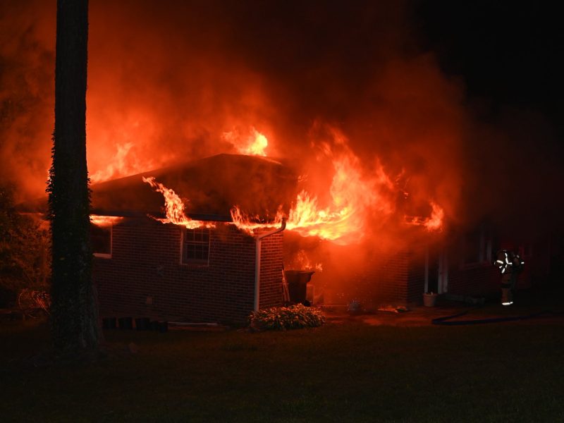 What We Know: Roswell firefighters responded to the house fire just before 9:30 p.m. Tuesday and arrived within minutes to find flames engulfing the carport and spreading to the roof. All residents evacuated safely before crews arrived, though one person received on-scene evaluation for minor burns.