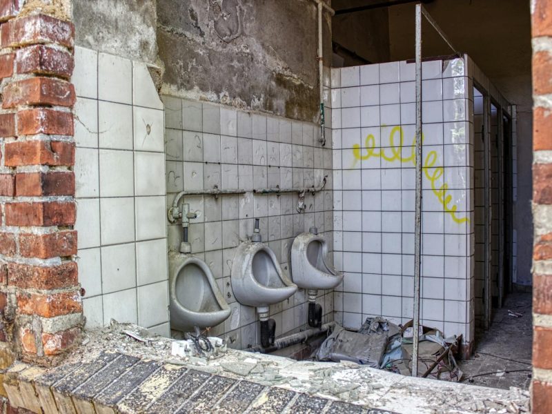Explore an abandoned restroom with decay and vandalism in Leipzig, Germany.