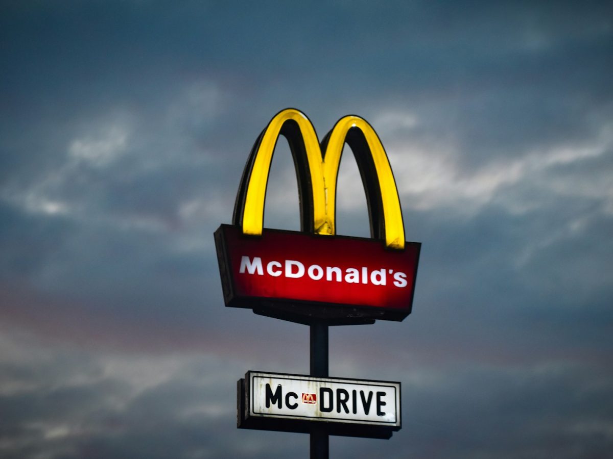a mcdonald's sign with a cloudy sky in the background