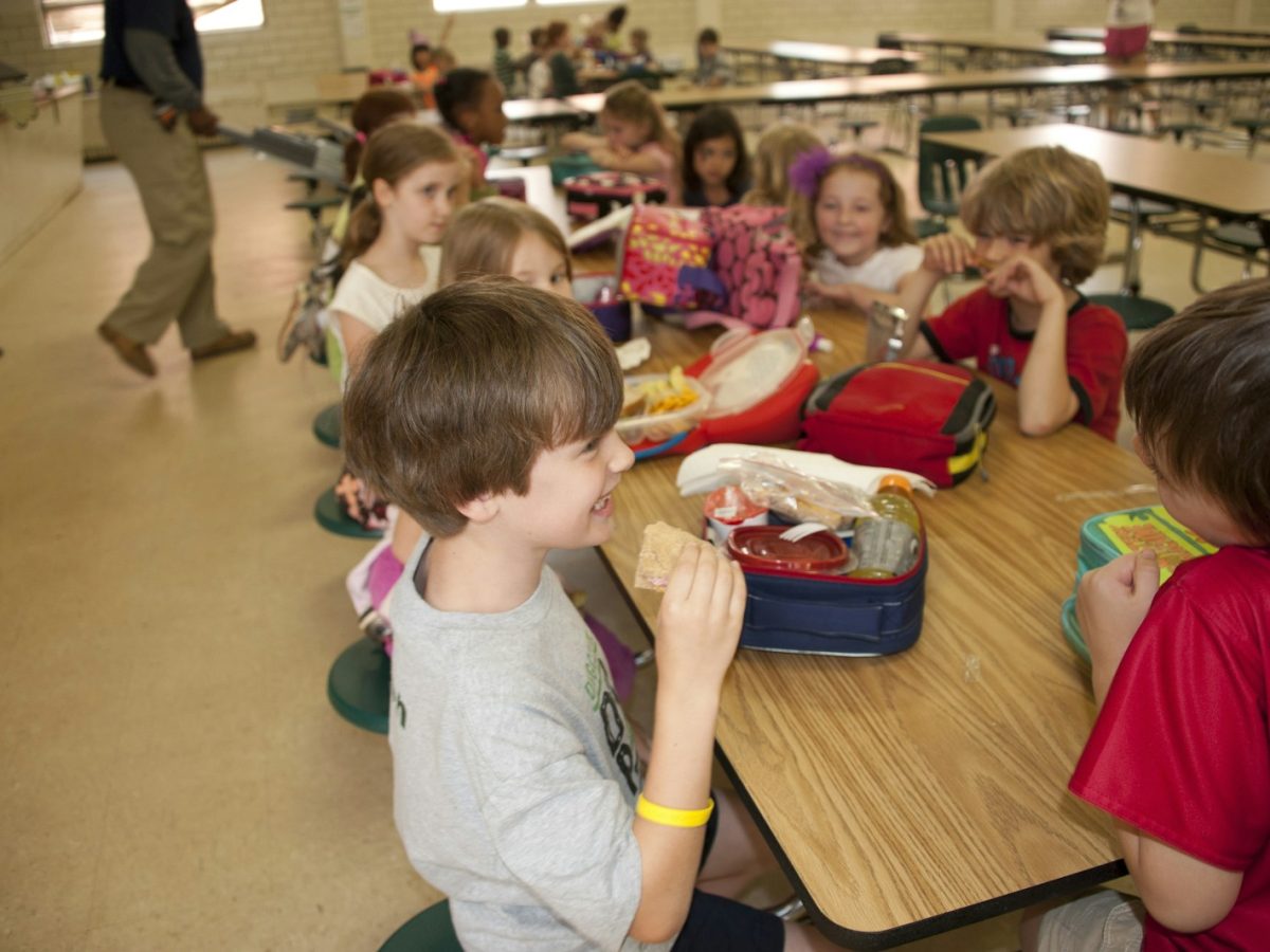 boy in gray crew neck t-shirt eating