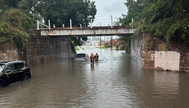 Savannah firefighters saved four people trapped in rising waters near downtown Saturday evening, narrowly avoiding disaster when they discovered a hidden danger beneath the flood.
