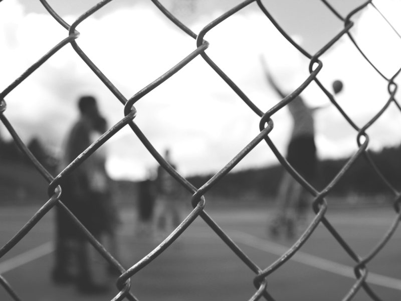 grayscale photo of cyclone fence