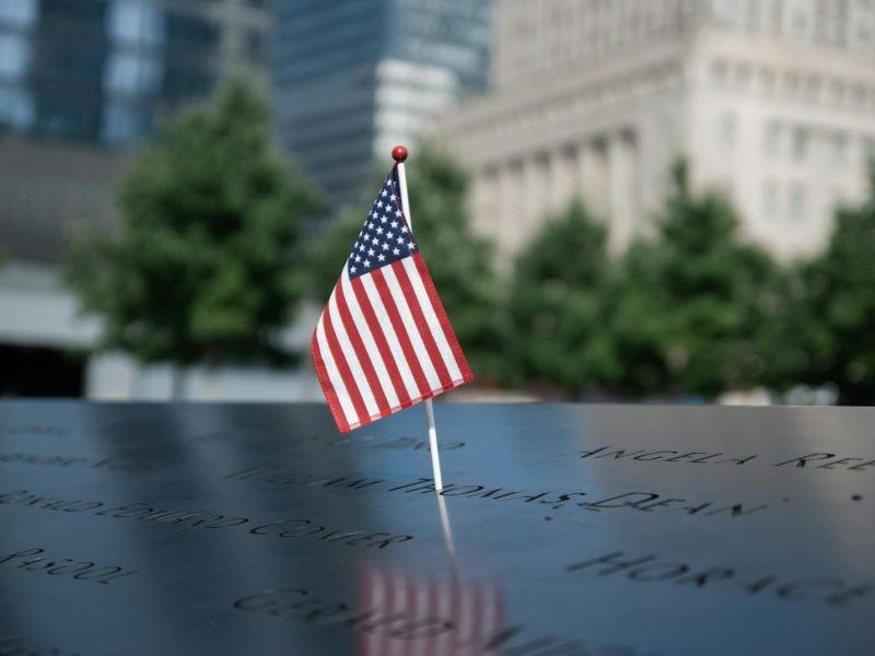 American flag at the 9/11 Memorial in NYC, symbolizing remembrance and patriotism.