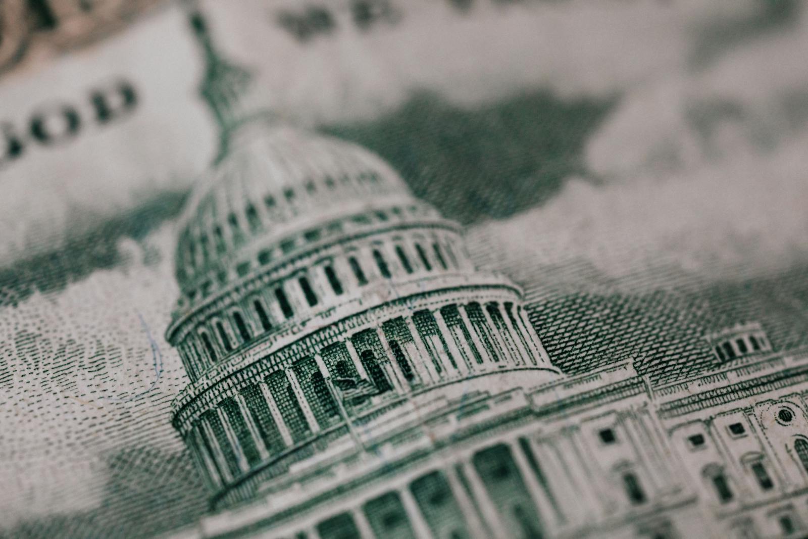 Close-up of the US Capitol illustration on American currency, showing detailed architectural design.