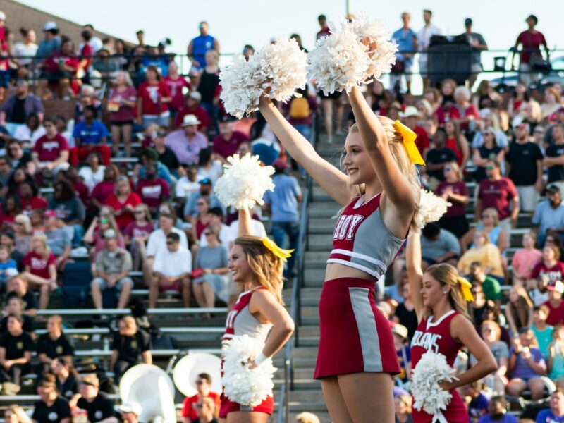 women in white and red uniform dancing on stage during daytime