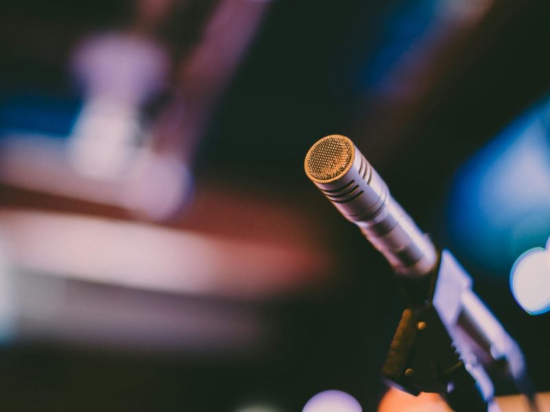 Detailed shot of a microphone with artistic bokeh background, ideal for concerts.