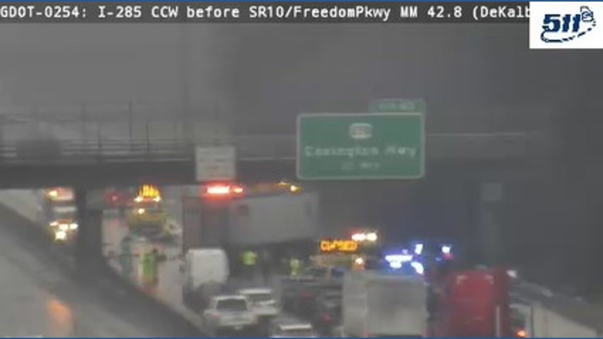 A section of I-285 southbound is closed after a car crash involving an 18-wheeler