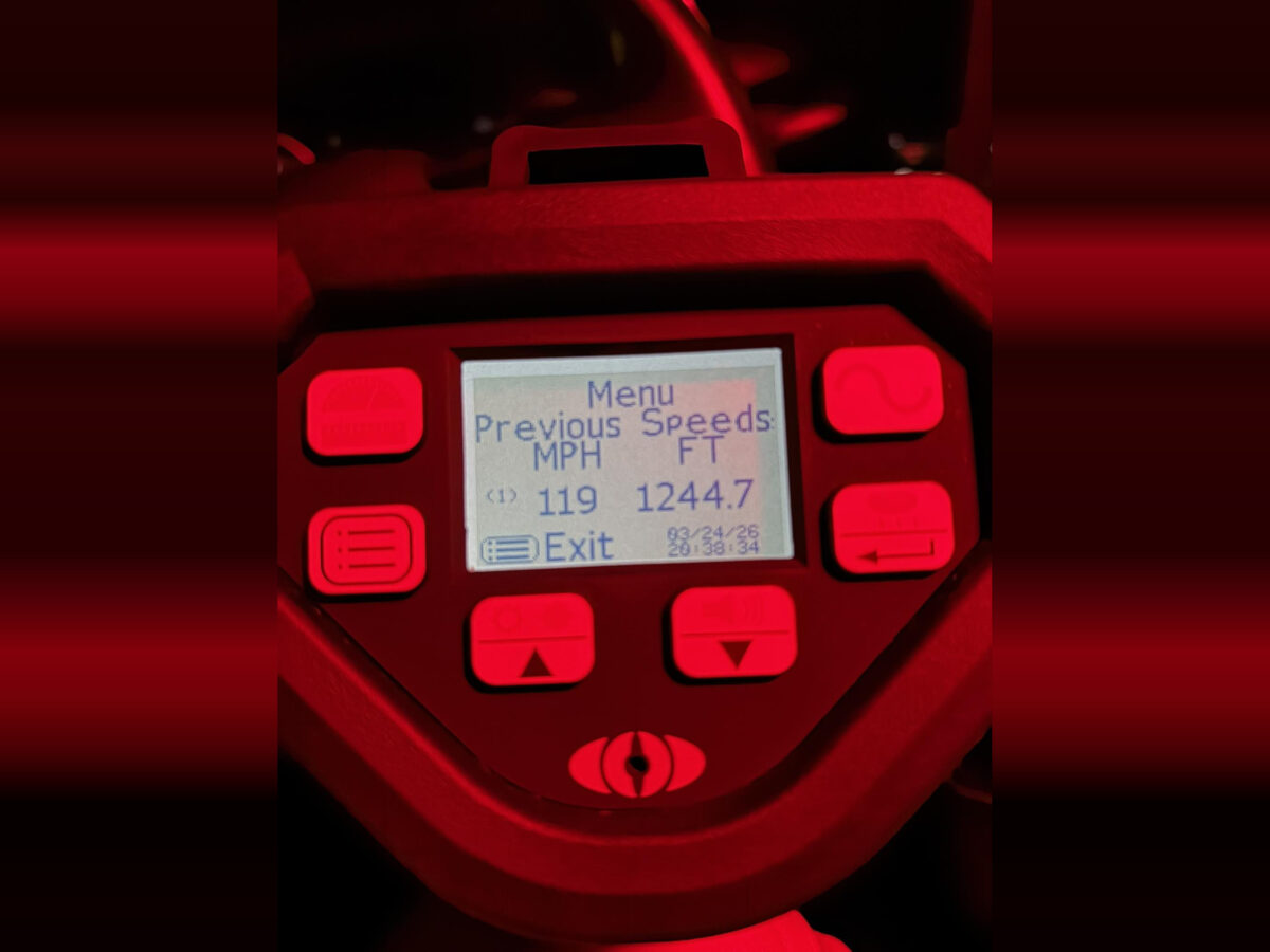 Digital radar or speed detection device screen displaying a menu with previous speeds: 119 MPH and 1244.7 FT. The screen shows the date 03/24/26 and time 20:38:34, surrounded by red-lit buttons.