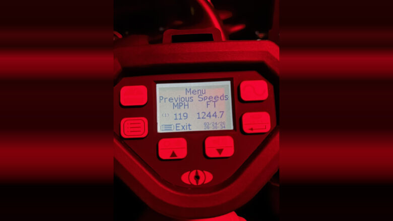 Digital radar or speed detection device screen displaying a menu with previous speeds: 119 MPH and 1244.7 FT. The screen shows the date 03/24/26 and time 20:38:34, surrounded by red-lit buttons.