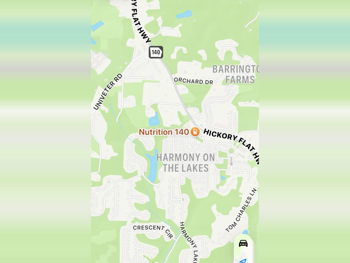 Map showing the area of Harmony on the Lakes, with nearby roads including Hickory Flat Hwy (Highway 140), Univeter Rd, Orchard Dr, Crescent Cir, Harmony Lakes Dr, and Tom Charles Ln. The location "Nutrition 140" is marked near the center of the map. Barrington Farms is indicated to the northeast. The map features residential streets and some bodies of water.