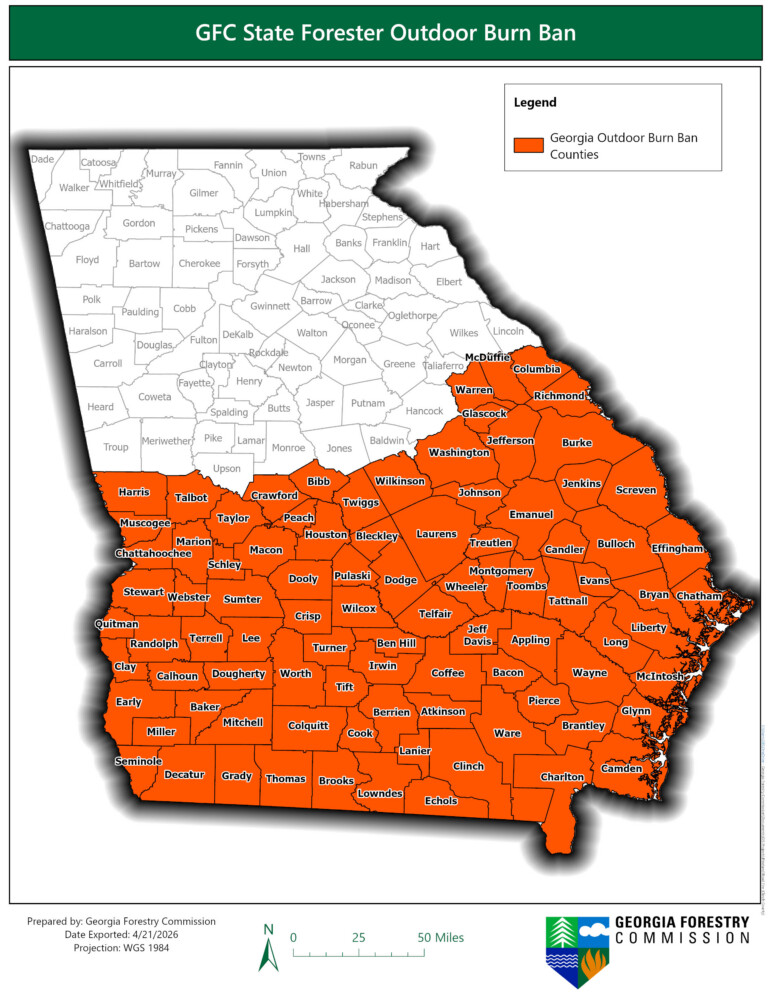 Map of Georgia highlighting counties under an outdoor burn ban by the Georgia Forestry Commission. The southern and eastern parts of the state are shaded in orange, indicating the burn ban areas, while the northern and western counties remain unshaded. The map includes county names and a legend specifying the orange color represents Georgia Outdoor Burn Ban Counties. A scale bar shows distances up to 50 miles, and the map is dated April 21, 2026.