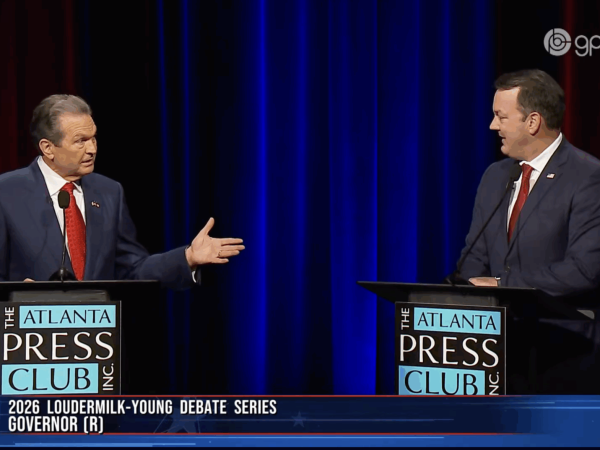 Two men in suits and red ties stand behind podiums labeled "The Atlanta Press Club Inc." They appear to be engaged in a debate, with one man gesturing toward the other. The background features blue and red curtains. Text at the bottom reads "2026 Loudermilk-Young Debate Series Governor (R)." Logos for GPB and PBS are visible in the upper right corner.