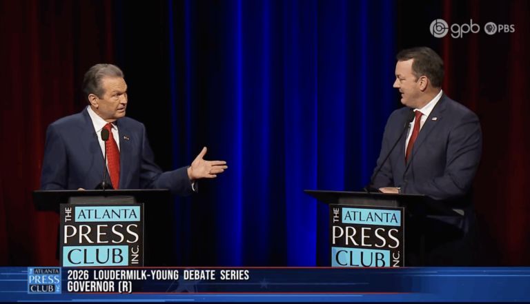 Two men in suits and red ties stand behind podiums labeled "The Atlanta Press Club Inc." They appear to be engaged in a debate, with one man gesturing toward the other. The background features blue and red curtains. Text at the bottom reads "2026 Loudermilk-Young Debate Series Governor (R)." Logos for GPB and PBS are visible in the upper right corner.