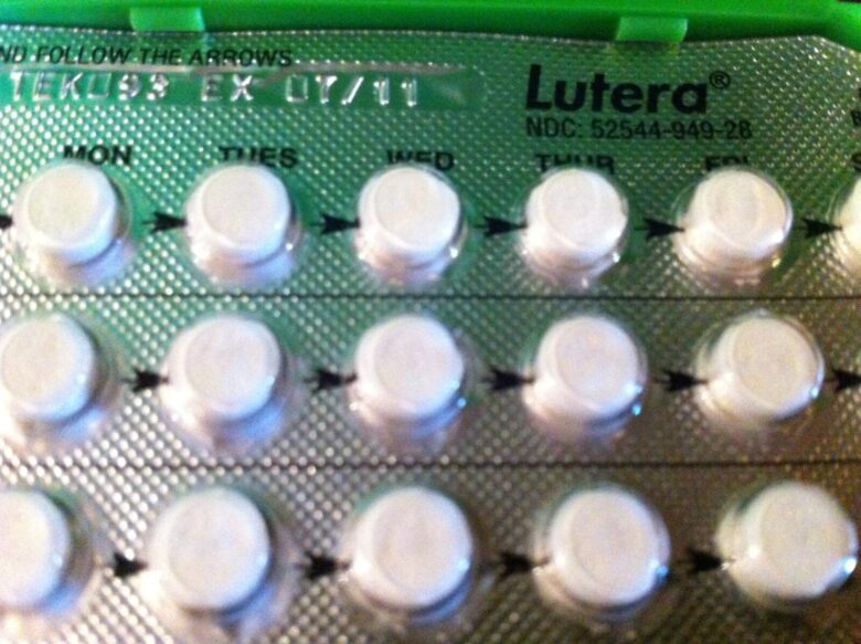 Blister pack of Lutera birth control pills with white round tablets arranged in rows, labeled with days of the week (Mon, Tues, Wed, Thur, Fri) and arrows indicating the order to take the pills. The packaging is silver with black text.