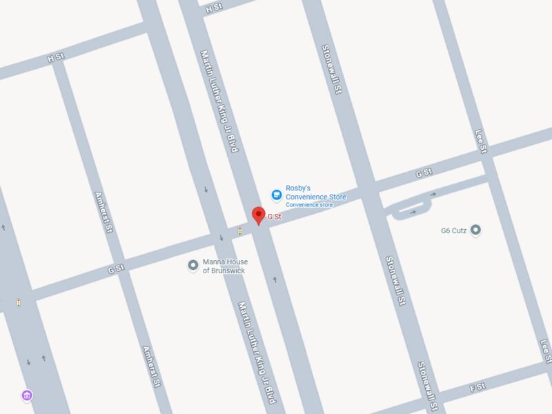 Map showing the intersection of G St and Martin Luther King Jr Blvd, with nearby streets including Albany St, Amherst St, Stonewall St, Lee St, Gordon St, Wolfe St, and H St. Notable locations marked are Rosby's Convenience Store, Manna House of Brunswick, Grace United Methodist, and G6 Cutz. Traffic lights are indicated at some intersections.