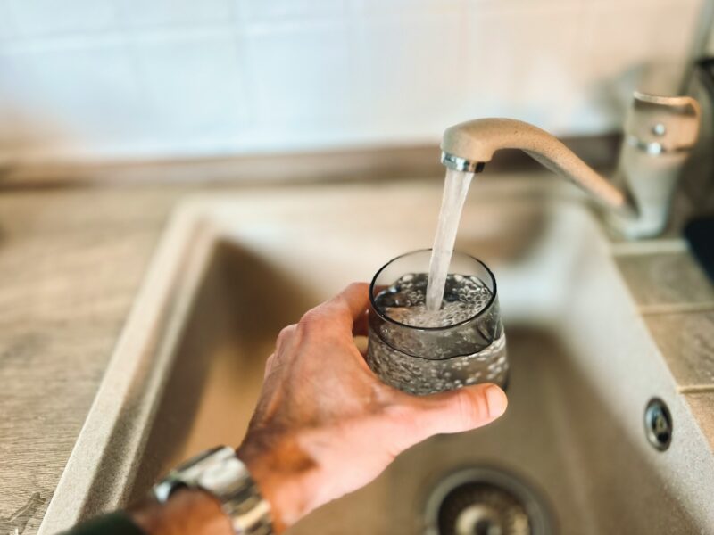 a hand holding a glass of water