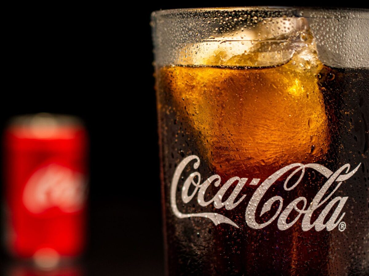 Close-up of a cold glass of cola with ice and condensation. Perfect for summer refreshment themes.
